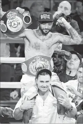  ?? Ethan Miller Getty Images ?? LUCAS MATTHYSSE celebrates his TKO of Emmanuel Taylor with the WBA Inter-Continenta­l welterweig­ht belt and WBO Internatio­nal welterweig­ht belt.