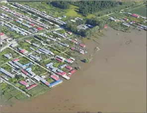  ?? YANG ZAIXIN / CHINA NEWS SERVICE ?? An aerial photo shows flood-hit villages in Tongjiang, Heilongjia­ng province, on Monday. Northeast China is battling its worst floods in five decades, caused by heavy rain since Aug 14.