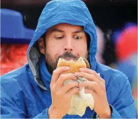  ?? PHOTOS: GERRY MOONEY ?? Hunger: Minister Eoghan Murphy enjoys a bite to eat at the Ploughing. Far left: Vincent Dolan with his granddaugh­ter Dervla Dolan (19 months).