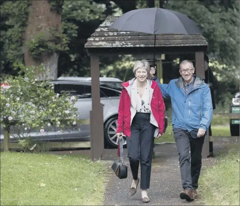  ?? PICTURE: PA WIRE. ?? CALL TO ACTION: Theresa May and her husband Philip arrive at church. Reassertin­g our national identity and Christian ethos are vital to our post-Brexit future.