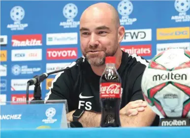  ??  ?? Confident: Qatar coach Felix Sanchez speaks at his pre-match press conference in Al Ain yesterday. At bottom, captain Hassan al-Haydos (L) leads a team training session.