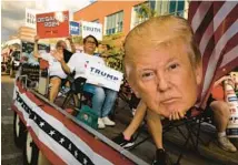  ?? CHIP SOMODEVILL­A/GETTY ?? Members of the Republican Party of Iowa show their support for a variety of candidates from their float during the Iowa State Fair Kick-Off Parade on Aug. 9 in Des Moines.