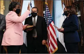  ?? (AP/Evan Vucci) ?? Vice President Kamala Harris (right) hosts a ceremonial swearing in Wednesday for U.S. Ambassador to the United Nations Linda Thomas-Greenfield at the Eisenhower Executive Office building on the White House campus. Holding the Bible is Thomas-Greenfield’s husband Lafayette Greenfield.