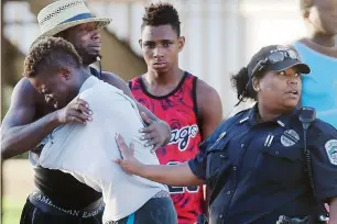  ?? AP ?? people console each other after the fatal shooting at Club Blu in Fort myers, Florida, on monday. —