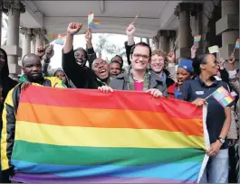  ?? PICTURE: DOCTOR NGCOBO ?? Unfurling the Lesbian, Gay, Bisexual, Transgende­r and Intersexed (LGBTI) rainbow pride flag at the Durban City Hall are, from left, Mdu Khuzwayo, vice-chairman of the ANC Youth League in KwaZulu-Natal, DA councillor Martin Meyer, and Nonhlanhla Mkhize...