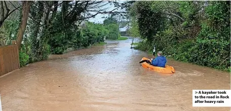  ?? ?? > A kayaker took to the road in Rock after heavy rain