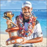  ??  ?? Indian golfer Gaganjeet Bhullar poses with the trophy after winning his maiden European Tour title on Sunday.