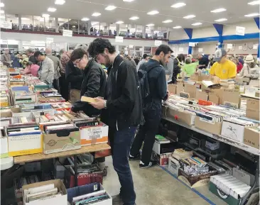  ??  ?? Book-loving bargain hunters take their pick of hundreds of thousands of volumes at the 20th annual Times Colonist Book Sale on Saturday. Editor-in-chief Dave Obee writes that the sale succeeded again because the community came together.