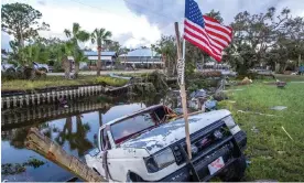  ?? Photograph: Cristóbal Herrera/EPA ?? A truck hangs on the ledge of a channel full of debris after the Hurricane Idalia made landfall.