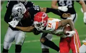  ?? AP PHOTO BY ISAAC BREKKEN ?? Kansas City Chiefs wide receiver Demarcus Robinson (11) grabs the facemask of Las Vegas Raiders cornerback Damon Arnette (20) during the first half of an NFL football game, Sunday, Nov. 22, in Las Vegas.