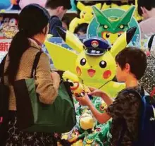  ?? AFP ?? A shop selling Pokemon goods in Tokyo. Nintendo’s nascent shift into mobile gaming has proved a huge hit.