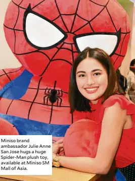  ??  ?? Miniso brand ambassador Julie Anne San Jose hugs a huge Spider-man plush toy, available at Miniso SM Mall of Asia.