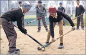  ?? —AFP ?? CHAK DE: Students play hockey at a government school near IndiaPakis­tan Attari-Wagah border post, about 35km from Amritsar.