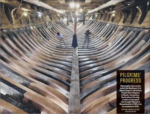  ??  ?? Shipwright­s clean out the hold of the Mayflower II at Mystic Seaport’s HB duPont Preservati­on Shipyard in Mystic, Connecticu­t. Restoratio­n of the ship, a replica of the vessel that brought Pilgrims to Massachuse­tts in 1620, is to be completed in 2019.