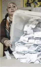  ?? — AFP ?? An electoral official sorts ballots in Cairo.