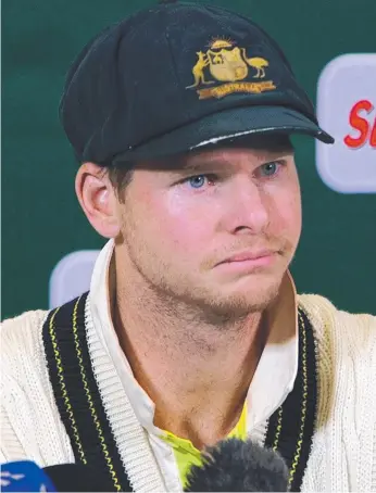  ?? Picture: AFP ?? Steve Smith tries on his sorry face as he admits to sanctionin­g ball tampering during a press conference in Cape Town at the weekend.