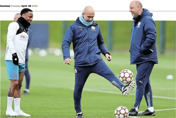  ?? / GETTY IMAGES / CHARLOTTE TATTERSALL ?? Pep Guardiola, Manager of Manchester City controls the ball as Raheem Sterling of Manchester City looks on during the Manchester City Training Session at Manchester City Football Academy in Manchester, England.