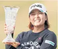  ?? AP ?? Ai Suzuki poses with the trophy.