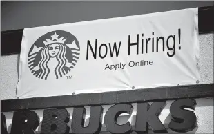  ?? Robyn Beck / AFP via Getty Images /TNS ?? A “Now Hiring” sign is displayed outside a Starbucks coffee shop in Glendale on July 7.