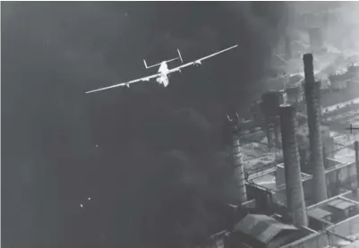  ??  ?? B-24D The Sandman of the 345th BS flown by 1st Lt. Bob Sternfels passing over the blazing refinery during the attack . (Photo via Jack Cook)