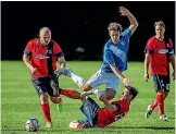  ?? PHOTO: WARWICK SMITH/STUFF ?? Massey’s Joe Freeman, centre, leaps out of the sliding tackle of Brandon Jackson of Red Sox-manawatu in their Federation League clash at Masey on Saturday.