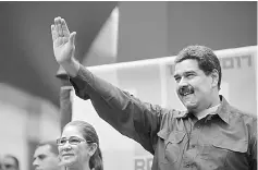  ??  ?? Venezuela’s President Maduro waves as he arrives for a rally with supporters in Caracas, Venezuela. Maduro’s socialist government has set a high-profile location near the presidenti­al palace in Caracas for a hotly awaited meeting with investors to...