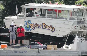  ??  ?? A duck boat is hauled out of the water in July 2018 after sinking during a storm at Table Rock Lake in Branson, Missouri. Seventeen people were killed in the sinking.