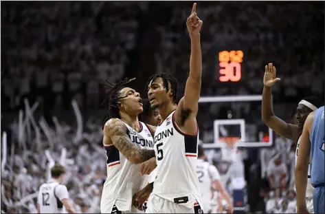  ?? JESSICA HILL — THE ASSOCIATED PRESS ?? Uconn guard Stephon Castle, right, celebrates with Solomon Ball against Creighton on Wednesday night in Storrs, Conn.