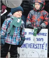  ?? MELINDA CHEEVERS NIAGARA THIS WEEK ?? Three-year-old Alex Craig of St. Catharines, left, and five-year-old Etienne Ayotte of Welland are among the many Niagara francophon­es who took to the streets of Beamsville Saturday for a demonstrat­ion outside of Niagara West MPP Sam Oosterhoff's office.