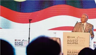  ??  ?? In the spotlight: Najib giving his keynote address at the 13th Invest Malaysia Kuala Lumpur.