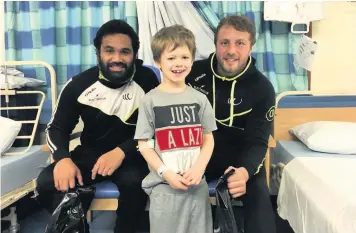  ??  ?? Patrick Ah Van and Chris Dean visiting the children’s ward at Warrington Hospital