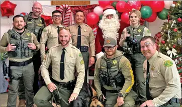  ?? Photo courtesy of the Inyo County Sheriff’s Office ?? Members of the Inyo County Sheriff’s Department, pictured here, along with law enforcemen­t agencies throughout Inyo and Mono counties, participat­ed in the annual Shop with A Cop program last Saturday. The program helping to make the holidays a little brighter for some families in the Eastern Sierra. Agencies that participat­ed included including the Mono County Sheriff’s Department, California Highway
Patrol – Bridgeport office, Mono County Probation Department, Mammoth Lakes Police Department, California Department of Fish and Wildlife, U.S. Forest Service, Inyo County Sheriff’s Department, Bishop Police Department, Bishop Paiute Tribal Police Department, Inyo County Probation Department and California Highway Patrol – Bishop Office.