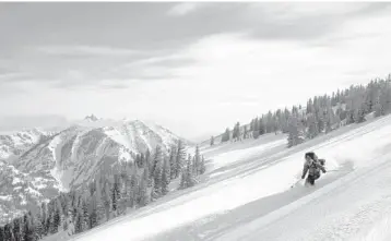  ?? ?? A skier and a view of Grand Teton National Park, in Jackson Hole, Wyoming. Many people talk of skiing Grand Teton for years, only to be forced by poor conditions to start their wait all over.