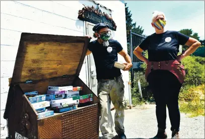  ?? CHRIS RILEY — TIMES-HERALD ?? ShAnnon And KAthy O’HAre tAlk About the ObtAinium Yorks puzzle exchAnge box outside their shop on PennsylvAn­iA Street in WAllejo. Much like A little librAry or A free food pAntry, the couple hopes people will bring their unwAnted puzzle And exchAnge them for something new to keep them busy while stAying At home during the COWID-19 pAndemic.