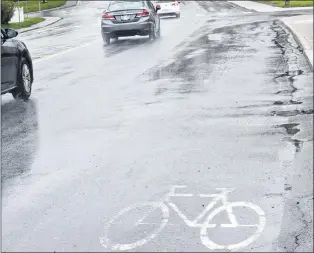  ?? JOE GIBBONS/THE TELEGRAM ?? Fading bicycle lane markings on Cowan Avenue just past the turnoff from Topsail Road heading north toward Canada Drive.