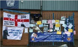  ??  ?? Banners, flags and messages adorn the gates of Gigg Lane after Bury’s Football League expulsion. Photograph: Visionhaus