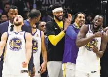  ?? Carlos Avila Gonzalez / The Chronicle ?? Stephen Curry screams as his Warriors teammates rejoice after Golden State locked down its third title in four years.