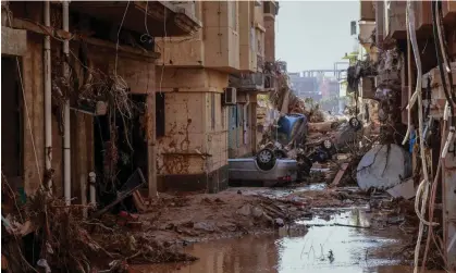  ?? ?? Overturned cars lay among other debris caused by flash floods in Derna, eastern Libya. Photograph: AFP/Getty Images