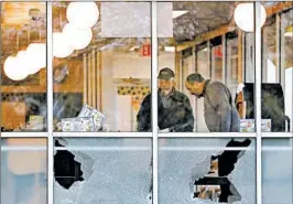  ?? MARK HUMPHREY/AP ?? Shot-out windows mark where a gunman opened fire at a Waffle House in Nashville, Tenn.
