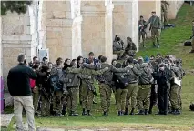  ?? PHOTO: REUTERS ?? Israeli soldiers hug each other near the scene where police said a Palestinia­n rammed his truck into a group of Israeli so in Jerusalem.