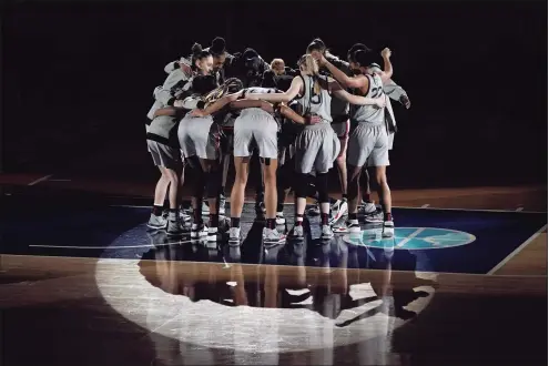  ?? Morry Gash / Associated Press ?? Connecticu­t players huddle before a women's Final Four NCAA college basketball tournament semifinal game against the Arizona Friday at the Alamodome in San Antonio.