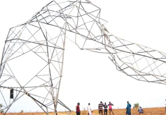  ??  ?? One of the electricit­y towers destroyed by storm along Tegina-Kontagora power line in Niger state last Friday