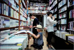  ?? PROVIDED TO CHINA DAILY ?? Customers look at books in All Sages Bookstore in Beijing. The Beijing government has announced a plan to help establish more than 150 bookstores over the next few years by providing $7.33 million per year, as physical stores face pressure from the e-commerce sector and the growing popularity of digital books.