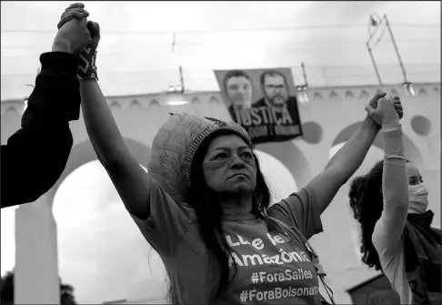  ?? BRUNA PRADO / ASSOCIATED PRESS FILE (2022) ?? Social and environmen­tal activists protest asking for justice in the deaths of British journalist Dom Phillips and Indigenous expert Bruno Pereira on June 26, 2022, at the Arcos da Lapa aqueduct in Rio de Janeiro.