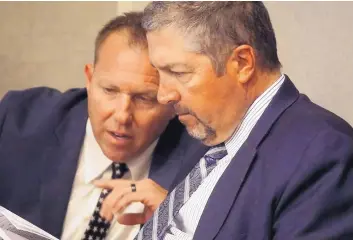  ?? ADOLPHE PIERRE-LOUIS/JOURNAL ?? Bernalillo County Sheriff’s Office Sgt. David Priemazon, left, confers with his attorney, Sam Bregman, before Monday’s hearing in Metro Court.