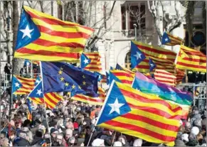  ?? JOSEP LAGO/AFP ?? People hold Catalan pro-independen­ce flags in Barcelona on February 6.