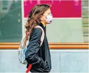  ?? /Getty Images/Light Rocket/Sopa Images/Robin Utrecht ?? Masked tasks: A girl returns to school at the end of Rotterdam’s lockdown.