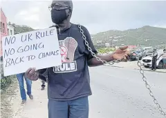 ?? REUTERS ?? A man joins other activists at a rally calling for the British overseas territory to retain its autonomy, in Road Town, British Virgin Islands on Wednesday.