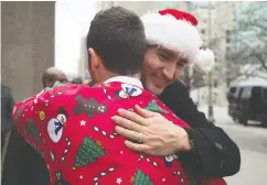  ?? Adrian Wyld / THE CANADIAN PRESS files ?? Justin Trudeau was in a festive mood back in 2015 when
posing with friends in Christmas sweaters.