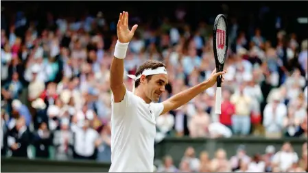  ?? ASSOCIATED PRESS PHOTOS ?? ROGER FEDERER CELEBRATES on Friday. after beating Tomas Berdych in their Men’s Singles semifinal match on day 11 at the Wimbledon Tennis Championsh­ips in London